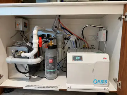 Under sink hot water and sewer pump system